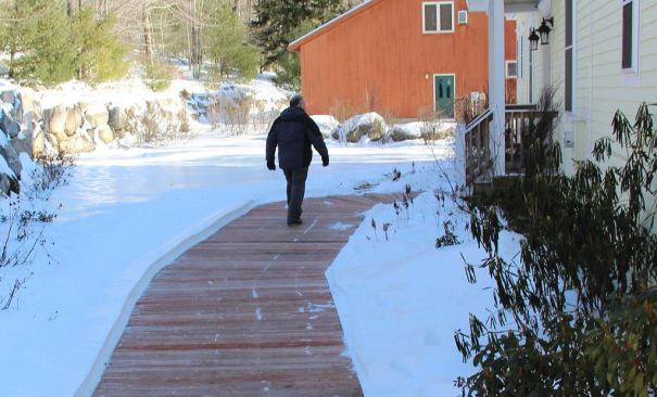 Wood treater Hal Bumby walks on a walkway installed on grade using lumber treated with micronized copper azole (MCA) and infused with an integral iron oxide color treatment. The wood is holding up well after several years in place. But the 5/4 boards, like all decking in the market today, are not treated to ground-contact levels and would not be warrantied. Bumby treated the wood at his own Maine facility, and he comments: “I’m a wood treater. And even I am using material that’s not recommended for this application. How can we expect contractors to know the difference?”