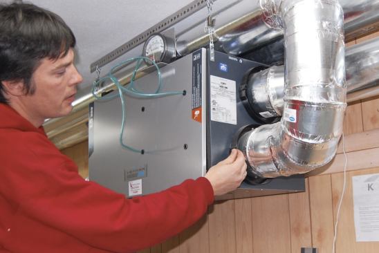 A heat-recovery ventilator (HRV) pulls in fresh outdoor air while exhausting stale air from indoors.