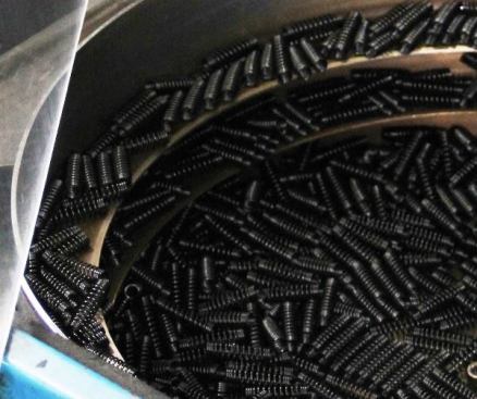 Look closely and you will see the springs used in Klein’s wire strippers. They’re being spun in a drum to orient them so they can be fed into an insertion machine.