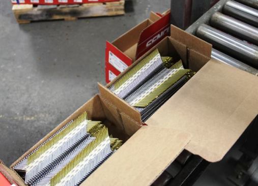 The finished strips of framing nails are boxed by machine. The person who closes the box stamps it with numbers indicating the date when the nails were made, the machine that made them, the person who operated the machine, and the coil of steel they came from. If a customer has problems with a box of fasteners Senco can trace them all the way back to the vendor that sold them the wire.