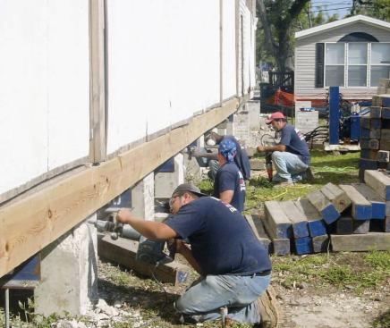 The shoring crew first disconnected the floor framing from the foundation by cutting the steel bolts embedded in the short concrete piers.