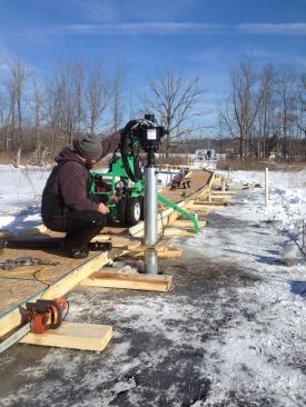 It was actually easier to install the piles once winter arrived and the wetlands froze over.