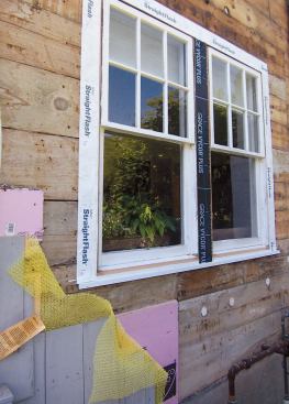 The jambs are flashed to the sheathing with self-adhering flashing tape.