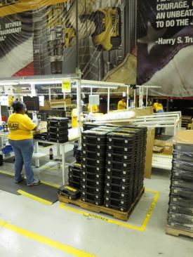 Tools, batteries, and chargers are being packaged in cases.