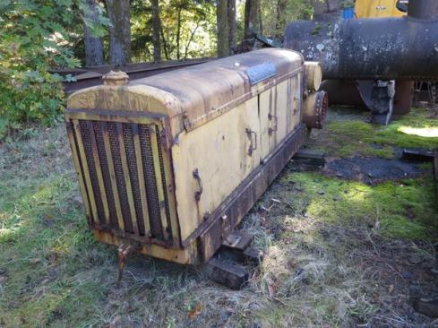The 1930’s era gas-powered compressor in this photo was made by Schramm Inc., a century-old Pennsylvania company that is still in existence. In the old days Schramm made compressors; it now specializes in truck- and trailer-mounted drilling equipment for wells, geothermal, and energy exploration. The compressor shown here would have originally been up off the ground on iron wheels; the piece sticking out the front is the hand crank for starting the engine.