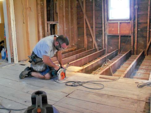 The quickest way to remove the old subfloor was to first saw along one of the joists near the middle of the floor. I set the blade of my circular saw at a shallow depth, so that I didn't inadvertently slice through anything under the floor. (Supply pipes for the old heating system had been turned off and drained.)