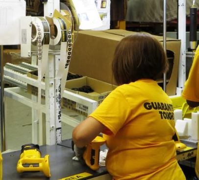 A whole bunch of labels are being applied to an 18-volt XRP recip saw. When the plant first opened it only manufactured XRP tools (which take the old post-style batteries). Now it produces XRP and 20V MAX.