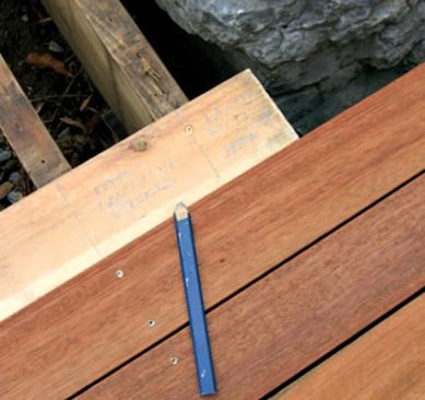 An example of the author's notations on story poles that he derived from the layout of the existing deck frame: The story poles enabled him to cut the individual lengths of decking in his shop rather than on site, which saved material handling.