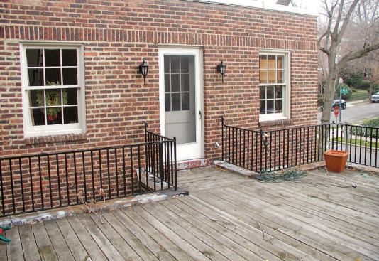 The existing pressure-treated deck covered a leaking roof membrane and rotted sheathing.