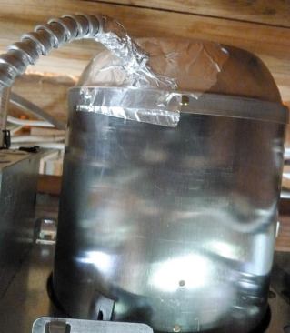 A strip of foil tape seals an air leak in an "airtight" ceiling can.