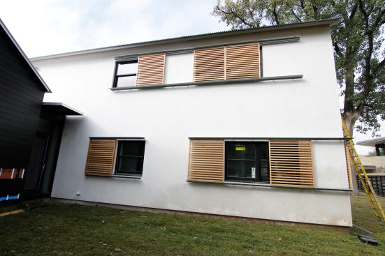 Traditional 3 coat stucco with LaHabre integral color finish. Rolling cedar shades look awesome!