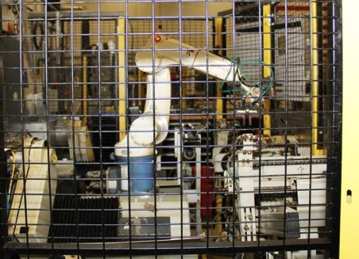 Once inside the cage the screwdriver shafts are picked up by the industrial robot shown here and placed into the machine that will grind the tips to final shape.