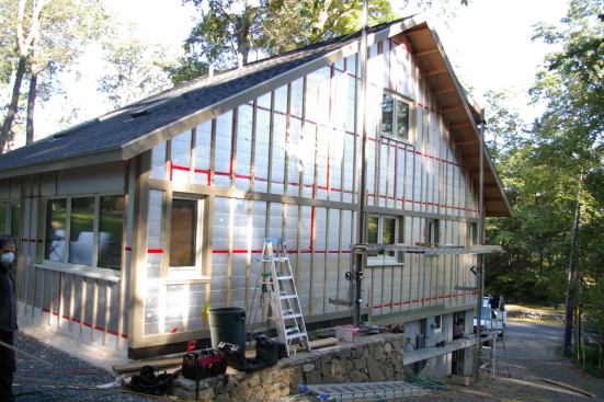 A second layer of foam was added over the first and held in place by lag bolts through the vertical 1x3s, which also create a rain screen for the Hardiplank siding.