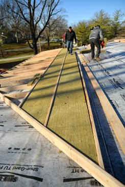 Increasing rafter spacing to 25 1/2 inches on-center allowed for 2-foot-wide R-20 insulation boards. The only insulation cuts required were at the valley.