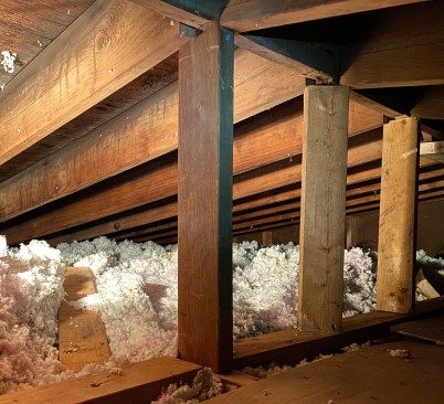 Initially, the author cut temporary support blocks from 2x4s and posted them down to a center bearing wall (in line with the center girder supporting the first floor).