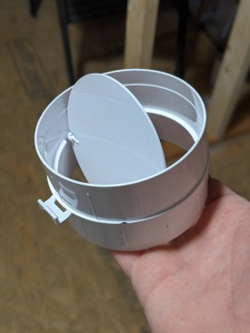 To further help prevent condensation, the author installs a secondary damper near the outlet, using this type of PVC backdraft damper, which is available online for around $10.