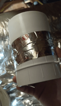 He can find the damper only in a 4-inch diameter, so he tapes it to a 3-inch PVC coupler.