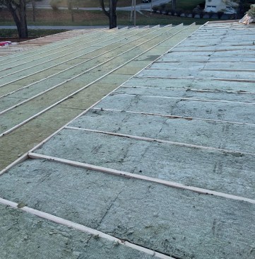 The ladder sections at the edges were framed 24 inches on-center to allow full shear nailing at sheathing edges where uplift and other forces are greater. These cavities were insulated with R-23 stone wool batts.