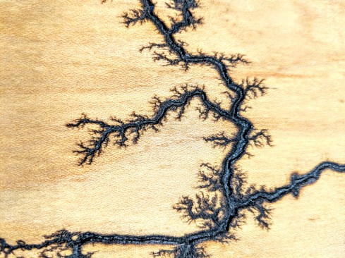 Gouging a path enables you to guide the burn. There will still be wood burn outside the path but the current gets drawn along nicely.