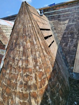 A view of one turret after the roof had been stripped shows the ridge that ties the top of the turret back to the Mansard-type roof plane. 
