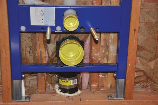 Carriers include adjustable legs so the installer can choose the fixture height. The fixtures are supported by threaded rods that protrude from the carrier.