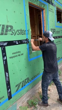 To help take the cost out of the system, the author does now use Zip System tape on the wide expanse of the walls. For these seams, rolling is critical to activate the pressure-sensitive tape adhesive. 