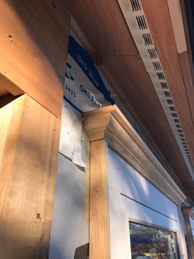 Fail. A wood head cap can serve as an effective way to shed water, but in this instance, it is a fail—the premilled drip kerf should have been installed face down, not up.