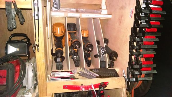 Nailers store in compartments just forward of the clamp storage. Note the compartment for gun oil at the top right corner.