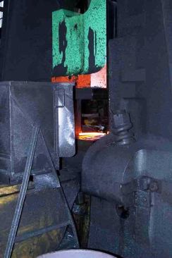 The machine hammers out the parts with nine tons of pressure while bouncing the ground floor of the factory like a continuous earthquake.