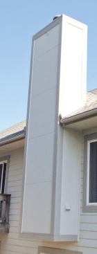 We replaced the original fiber-cement lap siding with 5/16-inch-thick HardiePanel stucco-textured fiber-cement panels.