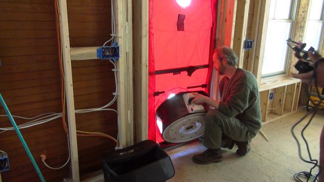 Installing the blower door fan into the door.