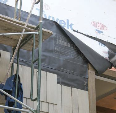 The building paper protects the wrap from the water-soluble extractives in red cedar.