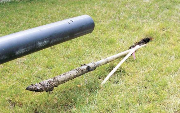 On this job, the angled bit emerged from the soil almost exactly on target about 100 feet away from the drilling rig; note the toppled marker stake leaning against the boring shaft.