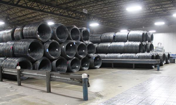 The wire shown here will be made into bright (non-galvanized) nails and staples. Each coil weighs approximately 3,000 pounds. Senco goes through more than 2,000 tons of wire per month; what you see here is less than one day’s supply for the factory.