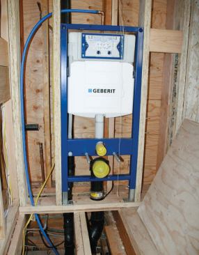 Double-wall framing behind the toilet allowed the waste pipe to be moved out from the foundation wall and made room for extra insulation.