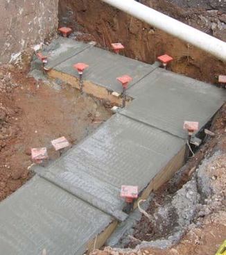 A jitterbug is used to give the footing an “alligator back,” which helps key the first course of block to the footing.