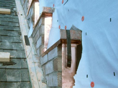 A double-layer WRB laps the back edge of the pan.