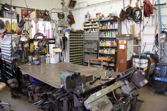 Maintenance and repairs are done in-house. This is part of a much larger maintenance shop filled with mechanic’s tools, parts and supplies, and equipment for cutting and welding.
