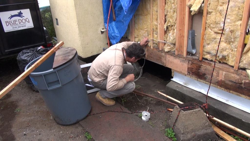 Gregor looks at a space he and his crew used to gain access to the home’s existing foundation and first floor frame, which required extensive reinforcing to get into compliance with California’s stringent seismic requirements. Fortunately, the existing framing had not suffered much deterioration, says Gregor — unlike many other similar structures in the area.