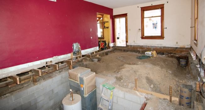 Around the perimeter of the building, a specialty subcontractor installed helical piers as close to the foundation walls as practical. Given the region's expansive clay soils, the lead helix was driven to a depth of around 30 feet.