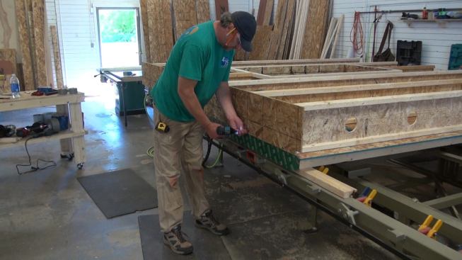 Attaching an OSB plate to the underside of the wood I-joist outer wall assembly. This portion of the wall base will extend out over the EPS foam perimeter insulation for the building’s reinforced raft slab, creating a thermal-bridge-free joint where the wall meets the foundation. (The site-built version of this detail is drawn and photographed in Chris Corson’s May, 2012, JLC feature, “An Affordable Passive House, Part 1”.)