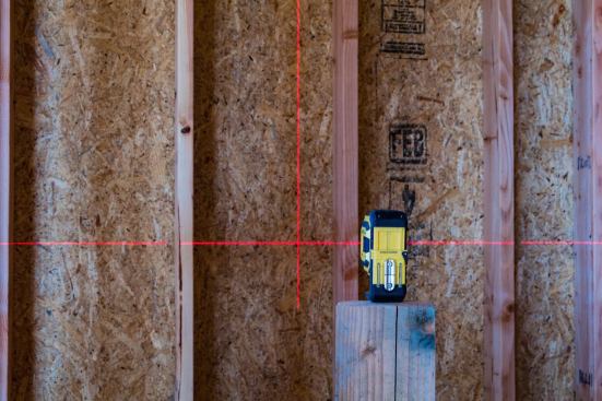 The LAX300 shoots a plumb and level lines and a plumb dot, and has an accuracy of 3/8" over 100'. Manufacturer specs say that the lines are visible up to 60', though that would depend on the lighting. The author found the lines plenty visible in larder rooms during the framing stages of construction.