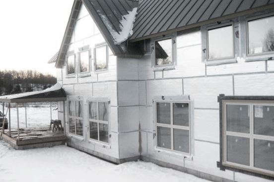 An exterior skin of foil-faced polyiso — with seams taped and windows tightly flashed — helps seal the shell and further reduces thermal bridging.
