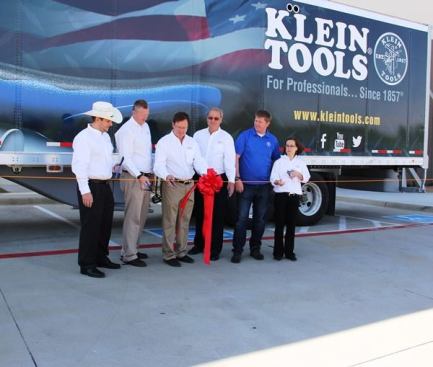 These folks are from the Klein family—which has owned the company since its founding in 1857. They are practicing for the ribbon-cutting ceremony that is about to take place. What do you think they are going to cut and what will they cut it with?