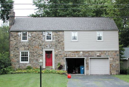 Before: An earlier master-bedroom addition above the garage was clad with vinyl siding.