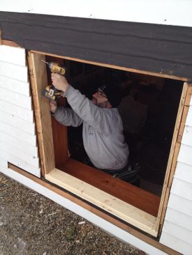 Plywood strips ripped in his shop beforehand screw to the original framing to build out the side jambs.