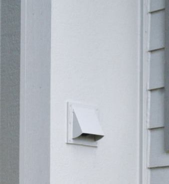 We replaced the existing plastic vent hood for the fireplace's makeup air supply with a metal one, mounting it on a PVC block and cutting the siding panel around it.