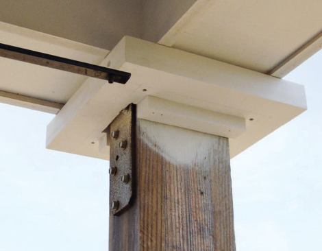 Installation began with the caps and bases of the structural post surrounds; small cleats attached just inside the column sides provide alignment and backing.