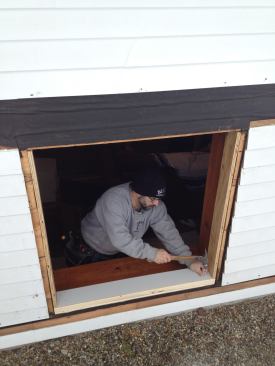 The taper of a length of primed clapboard material nailed flat on the sill will provide drainage for the opening.