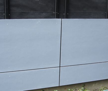 Fiber-cement wall panels were fastened with ring-shank stainless nails. Two battens were used at vertical joints, one on each side of the gap.